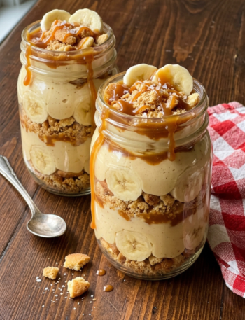 Banana pudding with salted caramel and vanilla wafer crumble in mason jars.