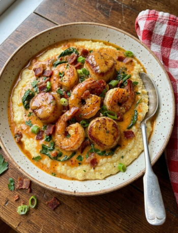 Cajun shrimp and scallops over creamy parmesan grits with buttery cream sauce.